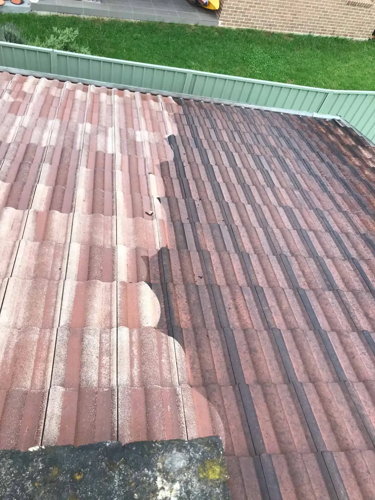 Looking up the pitch of a tiled roof mid-restoration